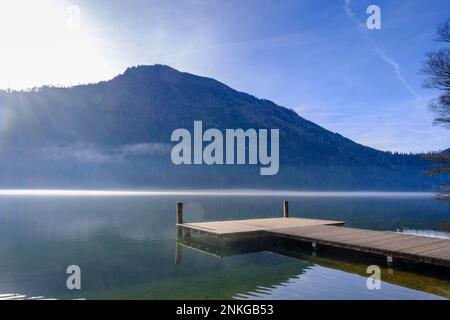 Austria, Lower Austria, Lunz am See, Jetty on shore of Lunzer See lake with Scheiblingstein mountain in background Stock Photo