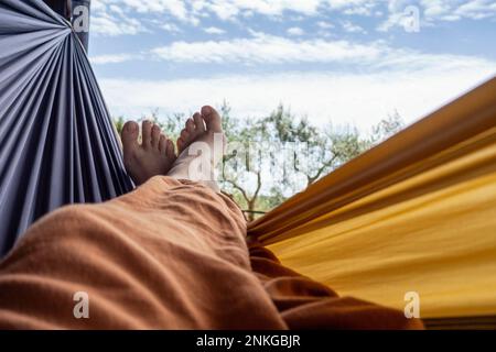 Mature woman relaxing in hammock Stock Photo