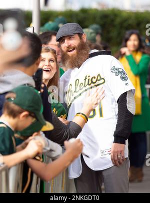 Former Oakland Athletics pitcher Dallas Braden wears a jersey of former San  Francisco Giants pitcher Tim Lincecum before a baseball game between the  Athletics and the Giants in Oakland, Calif., Friday, Aug.