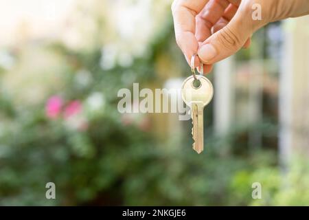 Hand of woman holding house key Stock Photo