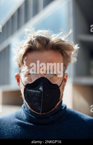 Businessman with protective face mask wearing eyeglasses Stock Photo