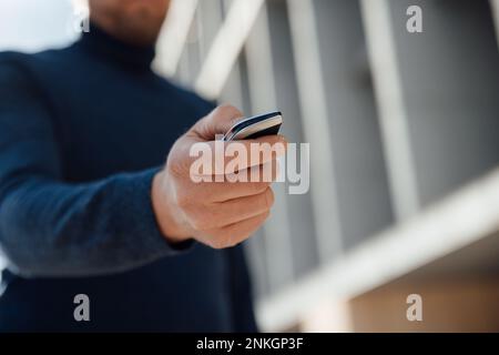 Hand of man holding car key Stock Photo