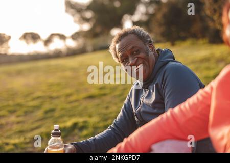 Smiling senior man looking at woman in park Stock Photo