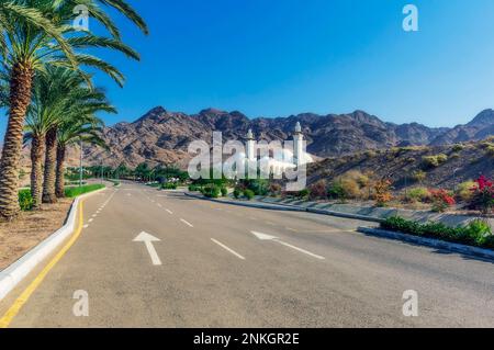 Empty road by Sheikh Zayed Mosque on sunny day Stock Photo