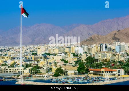 Jordanian Flag on tall pole in Aqaba city Stock Photo