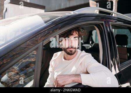 Thoughtful young man sitting in car Stock Photo