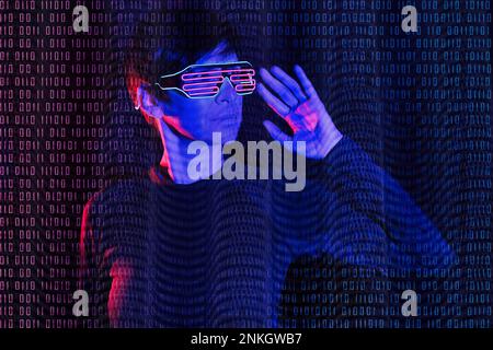Mature woman wearing futuristic glasses with binary code Stock Photo