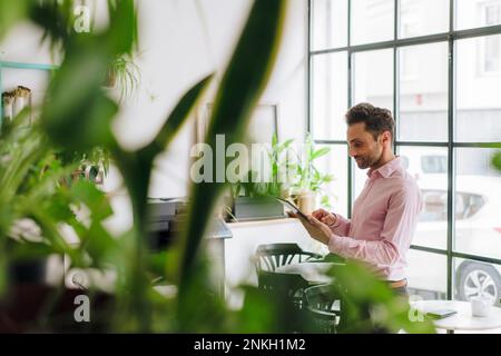 Mature businessman working on tablet PC in office Stock Photo