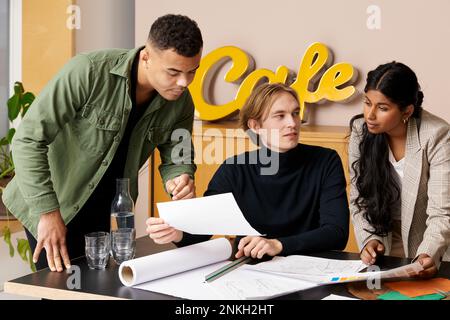 Fashion designers planning together at desk in studio Stock Photo