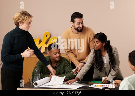 Multiracial fashion designers working together in studio Stock Photo