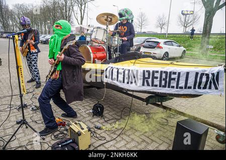 Delft, Netherlands, 22/02/2023, Ocean Rebellions heavy metal band 'Polymetallic Nodules' using a boat as a stage, sing denouncing the engineering company with lyrics critical of the ocean mining industry and to the environmental damage caused by deep-sea mining. Office workers at 'Allseas Engineering' received an impromptu concert from Ocean Rebellions heavy metal band 'Polymetallic Nodules' while using a boat as a stage. Songs were sang denouncing the engineering company with lyrics critical of the ocean mining industry and to the environmental damage caused by deep-sea mining. Allseas was on Stock Photo