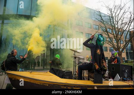 Delft, Netherlands, 22/02/2023, Ocean Rebellions heavy metal band 'Polymetallic Nodules' in a cloud of yellow smoke and using a boat as a stage, sing denouncing the engineering company with lyrics critical of the ocean mining industry and to the environmental damage caused by deep-sea mining. Office workers at 'Allseas Engineering' received an impromptu concert from Ocean Rebellions heavy metal band 'Polymetallic Nodules' while using a boat as a stage. Songs were sang denouncing the engineering company with lyrics critical of the ocean mining industry and to the environmental damage caused by  Stock Photo