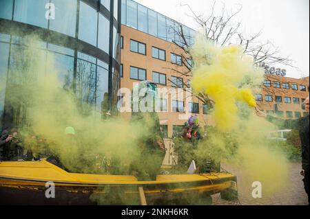 Delft, Netherlands, 22/02/2023, Ocean Rebellions heavy metal band 'Polymetallic Nodules' in a cloud of yellow smoke and using a boat as a stage, sing denouncing the engineering company with lyrics critical of the ocean mining industry and to the environmental damage caused by deep-sea mining. Office workers at 'Allseas Engineering' received an impromptu concert from Ocean Rebellions heavy metal band 'Polymetallic Nodules' while using a boat as a stage. Songs were sang denouncing the engineering company with lyrics critical of the ocean mining industry and to the environmental damage caused by  Stock Photo