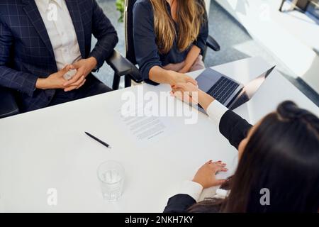 Candidate doing handshake with recruiter after interview at office Stock Photo