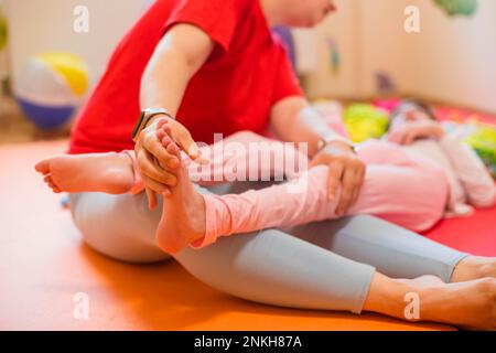 Physical therapist examining cerebral palsy patient's foot Stock Photo