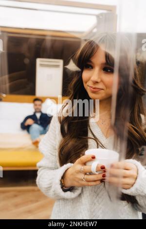Thoughtful young woman holding coffee cup in dome Stock Photo