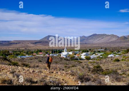 South Africa, Western Cape Province, Prince Albert, Hiker following footpath in front of desert town in Great Karoo Stock Photo