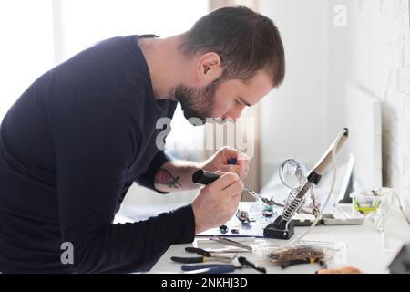 Focused engineer working with hand tools at workshop Stock Photo
