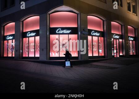 A pedestrian walks along a closed Cartier boutique in the center