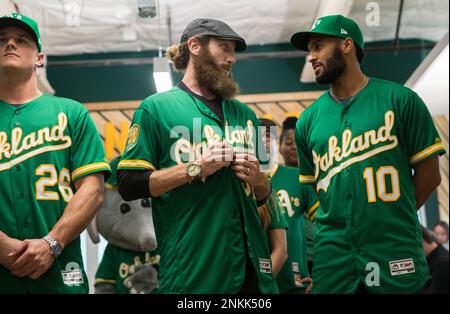 Former Oakland Athletics pitcher Dallas Braden wears a jersey of former San  Francisco Giants pitcher Tim Lincecum before a baseball game between the  Athletics and the Giants in Oakland, Calif., Friday, Aug.