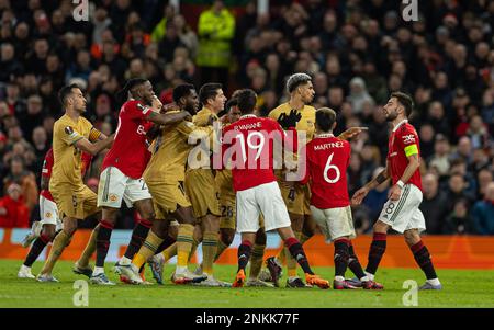 Manchester, UK. 24th Feb, 2023. Manchester United's Bruno Fernandes (1st, R) clashes with Barcelona players during the UEFA Europa League play-off 2nd leg match between Manchester United and Barcelona in Manchester, Britain, Feb. 23, 2023. Credit: Xinhua/Alamy Live News Stock Photo