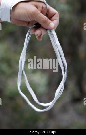 A sling is made of nylon woven into a flat tube an inch across. It is very  strong and unlike climbing rope, it does not stretch under tension. Part of  the equipment