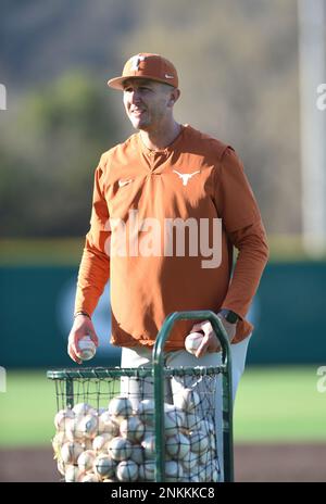 Texas Longhorns assistant coach Troy Tulowitzki (second from left) and Texas  Longhorns student assistant Huston Street (second from right) watch the  action from the dugout during the game against the LSU Tigers