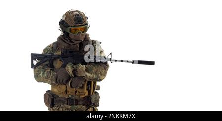 Professional mercenary soldier during an operation standing and looking at camera. A professional fighter during an operation behind enemy lines. Phot Stock Photo