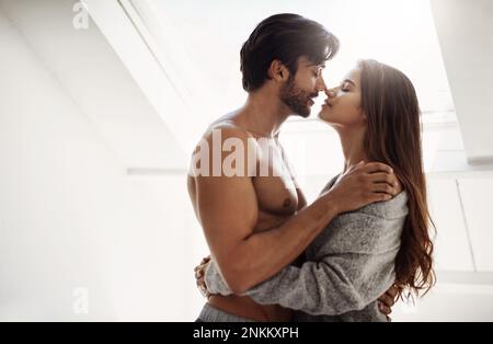 Being in love is wonderful. an affectionate young couple in their bedroom at home. Stock Photo