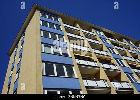An architectural structure featuring a vibrant design with multiple glass windows Stock Photo