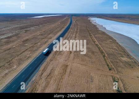 Aerial view of the P216 Elista - Astrakhan highway at the Mazna-Khag salt lake. Republic of Kalmykia, Russian Federation Stock Photo