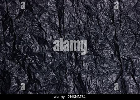 Abstract background of black crumpled satin paper Stock Photo