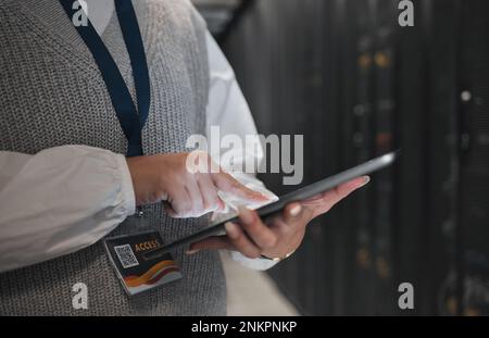 Woman, hands and tablet in server room for networking, inspection or checking systems at office. Hand of female technician or engineer with Stock Photo