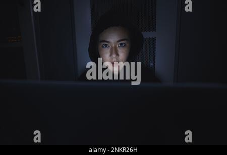 Night, hacker and cyber security with woman and laptop for coding, software and programming. Ransomware, phishing and developer with girl programmer Stock Photo