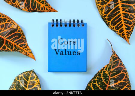 Core values business concept. Word written on blue notepad. Beautiful nature minimalist flat lay composition. Stock Photo