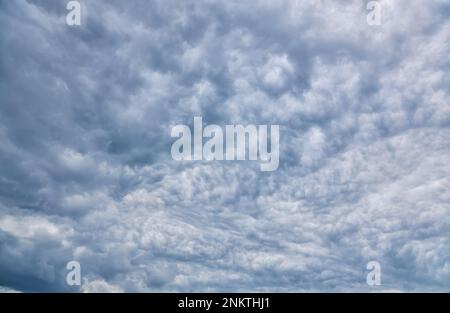 cloudy and gloomy sky. Shades of gray and white in full frame. Stock Photo
