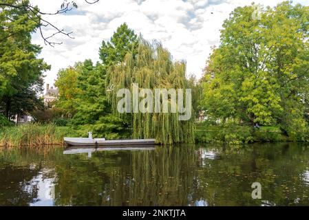 Gray working boat in the canal, Leiden, Netherlands Stock Photo