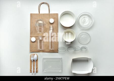 Various disposable tableware bottles and containers on a white background. Horizontal Stock Photo