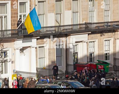 Ukrainian Consulate, Edinburgh, Scotland, UK. 24 February 2023. A small crowd gathers to mark  the 1st anniversary since Russia’s invasion of Ukraine. Pictured: Flag raising and moment of silence-Ukrainian Consulate, Windsor Street Edinburgh, Scotland, UK. Credit: Archwhite/alamy live news. Stock Photo