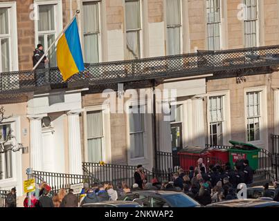 Ukrainian Consulate, Edinburgh, Scotland, UK. 24 February 2023. A small crowd gathers to mark  the 1st anniversary since Russia’s invasion of Ukraine. Pictured: Flag raising and moment of silence-Ukrainian Consulate, Windsor Street Edinburgh, Scotland, UK. Credit: Archwhite/alamy live news. Stock Photo