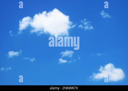 Fluffy Pure White Clouds Floating on Vivid Blue Sky Stock Photo