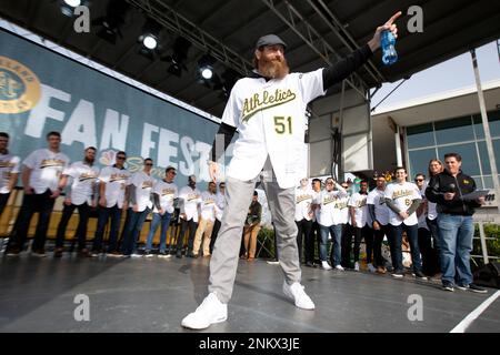 Former Oakland Athletics pitcher Dallas Braden wears a jersey of former San  Francisco Giants pitcher Tim Lincecum before a baseball game between the  Athletics and the Giants in Oakland, Calif., Friday, Aug.