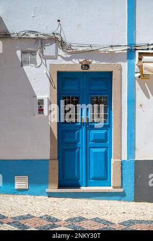 An old painted door in a old buildling in Lagos Algarve Portugal showing the traditional architecture. Stock Photo
