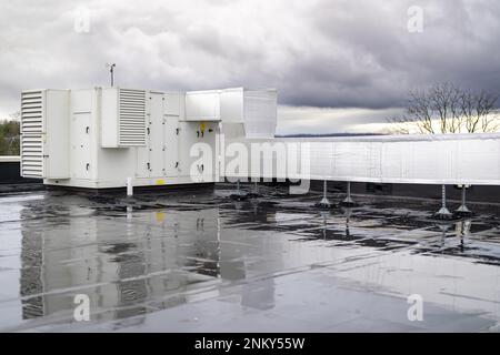 Air conditioning compressor units install on the roof of a commercial building. Stock Photo