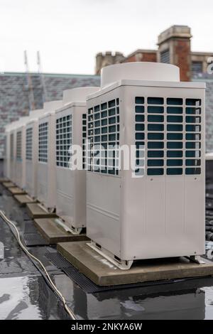 Air conditioning compressor units install on the roof of a commercial building. Stock Photo