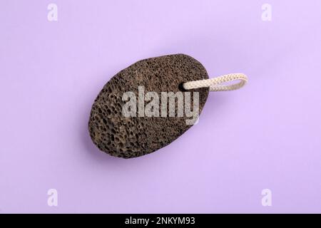 Pumice stone on violet background, top view Stock Photo