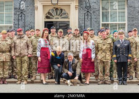 Downing Street, London, UK. 24th February 2023.  Larry the Cat welcomes the Ukrainian Ambassador to the UK, Vadym Prystaiko and his wife Inna outside number 10 Downing Street, to mark the one-year anniversary of the full-scale Russian invasion of Ukraine. Photo by Amanda Rose/Alamy Live News Stock Photo