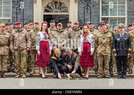 Downing Street, London, UK. 24th February 2023.  Larry the Cat welcomes the Ukrainian Ambassador to the UK, Vadym Prystaiko and his wife Inna outside number 10 Downing Street, to mark the one-year anniversary of the full-scale Russian invasion of Ukraine. Photo by Amanda Rose/Alamy Live News Stock Photo