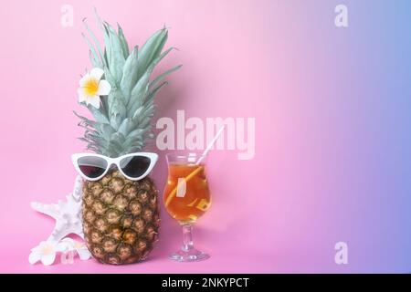 Funny pineapple with cocktail, plumeria flowers and starfish on color background, space for text. Summer party Stock Photo