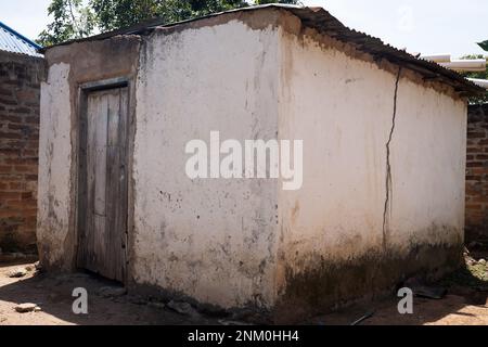 Old building with wooden door and cracked wall Stock Photo
